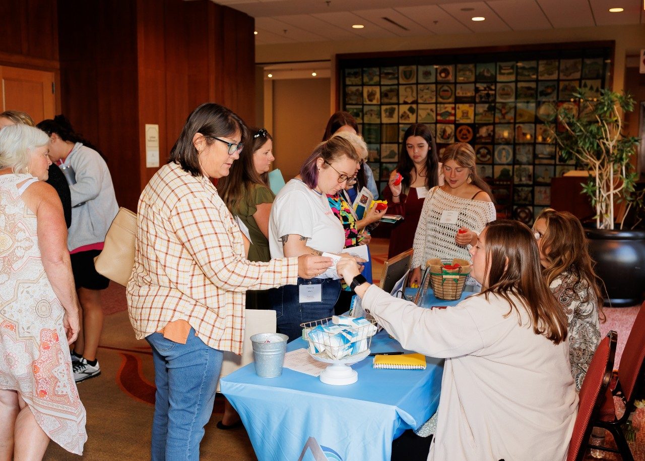 Participants visiting one of the 13 vendor tables that were present at the symposium throughout the day